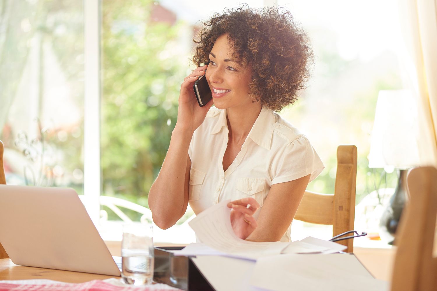 smiling woman talking on phone
